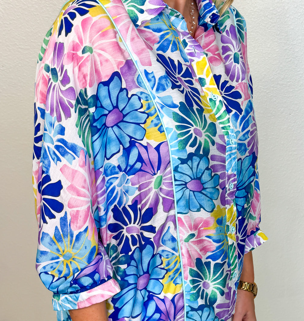 model wearing a vibrant floral top closeup