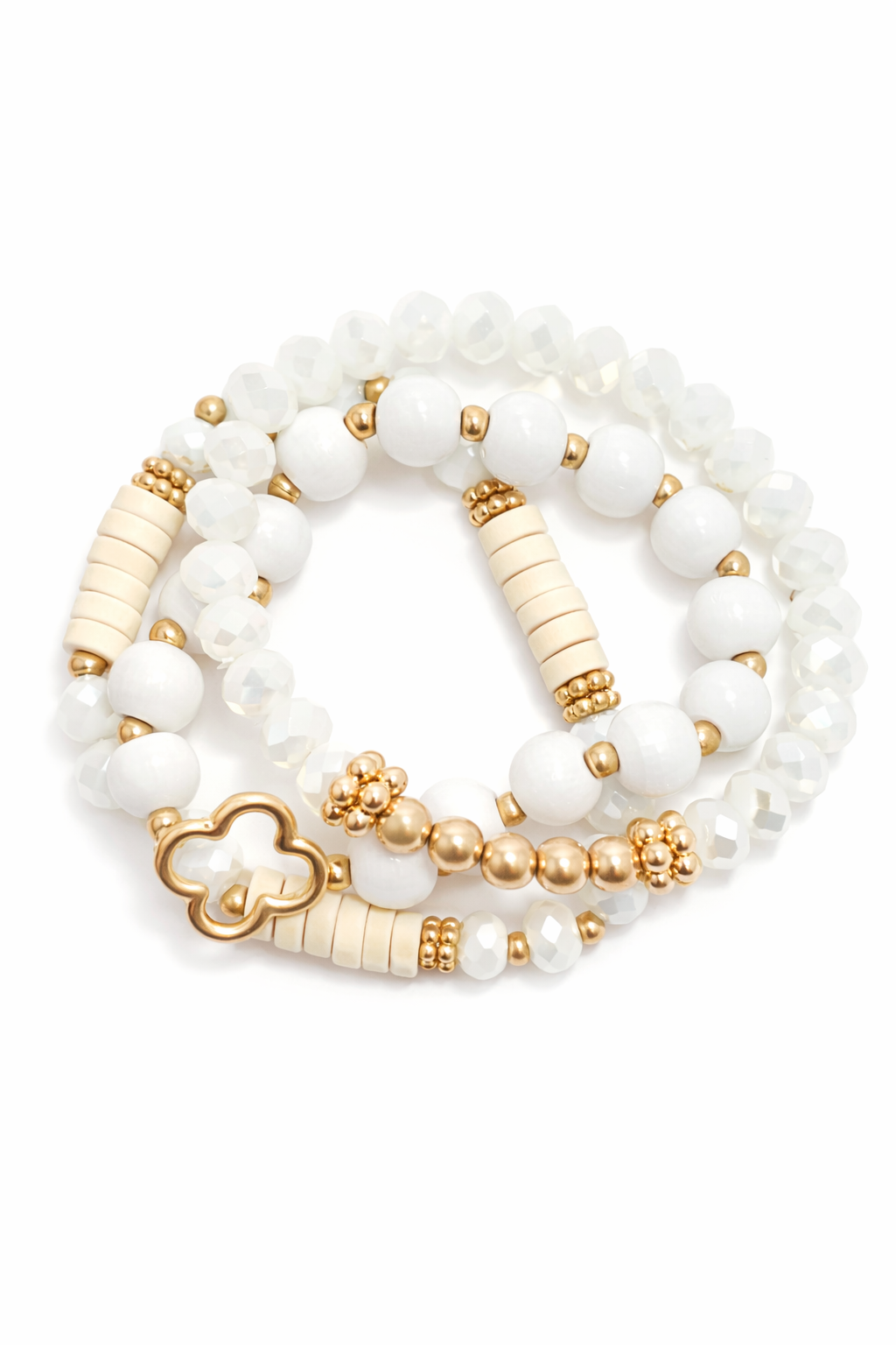 Set of white and gold beaded bracelets on a white background