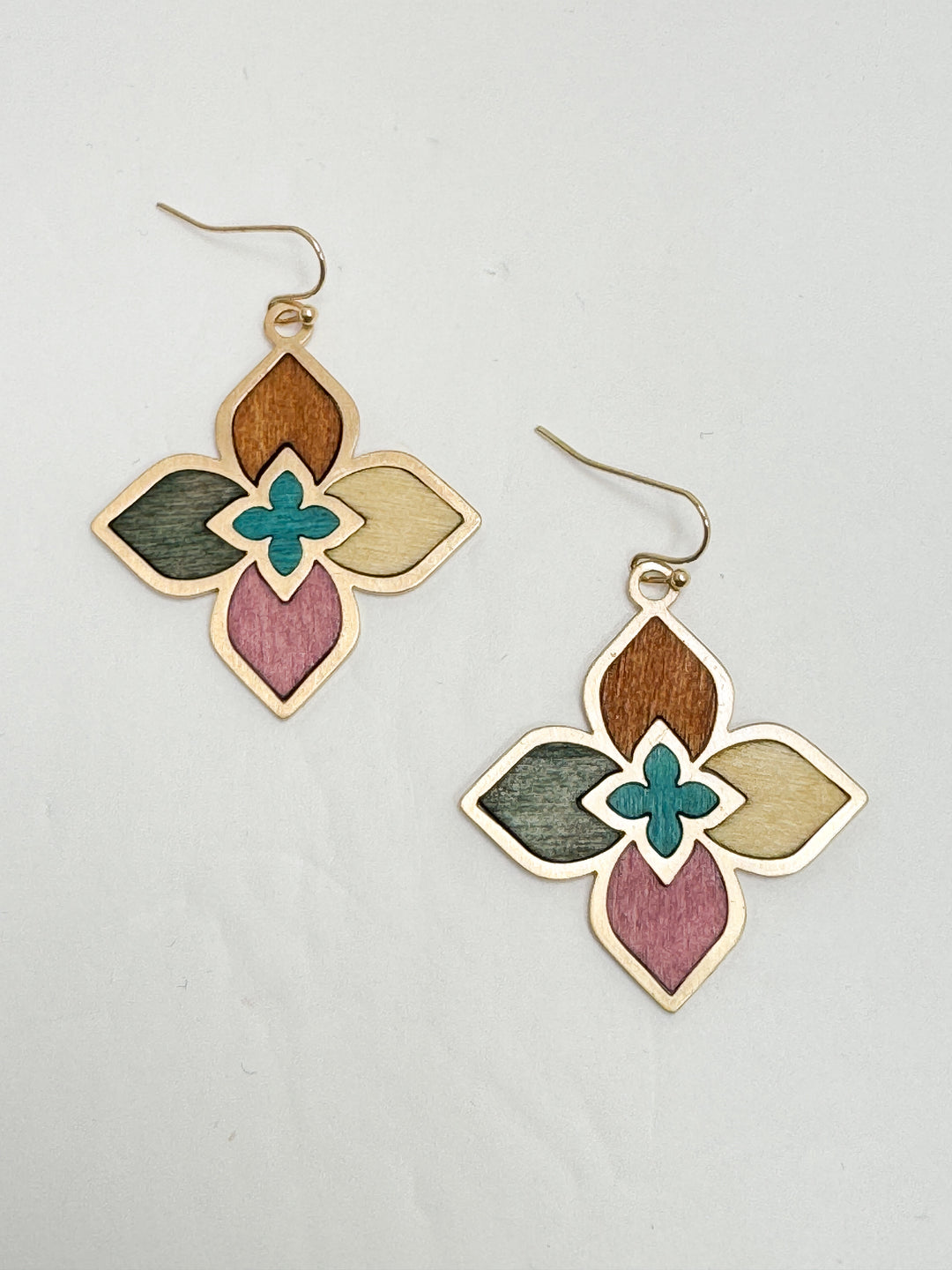 Colorful floral earrings on a light gray background