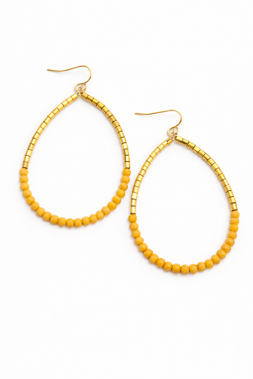 Gold hoop earrings with yellow beads on a white background