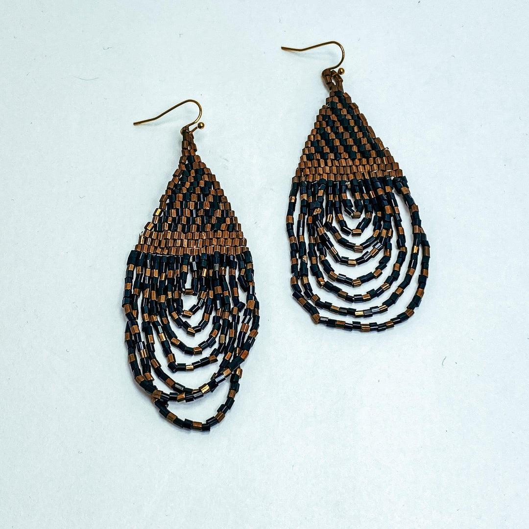 brown and black beaded statement earrings on white background