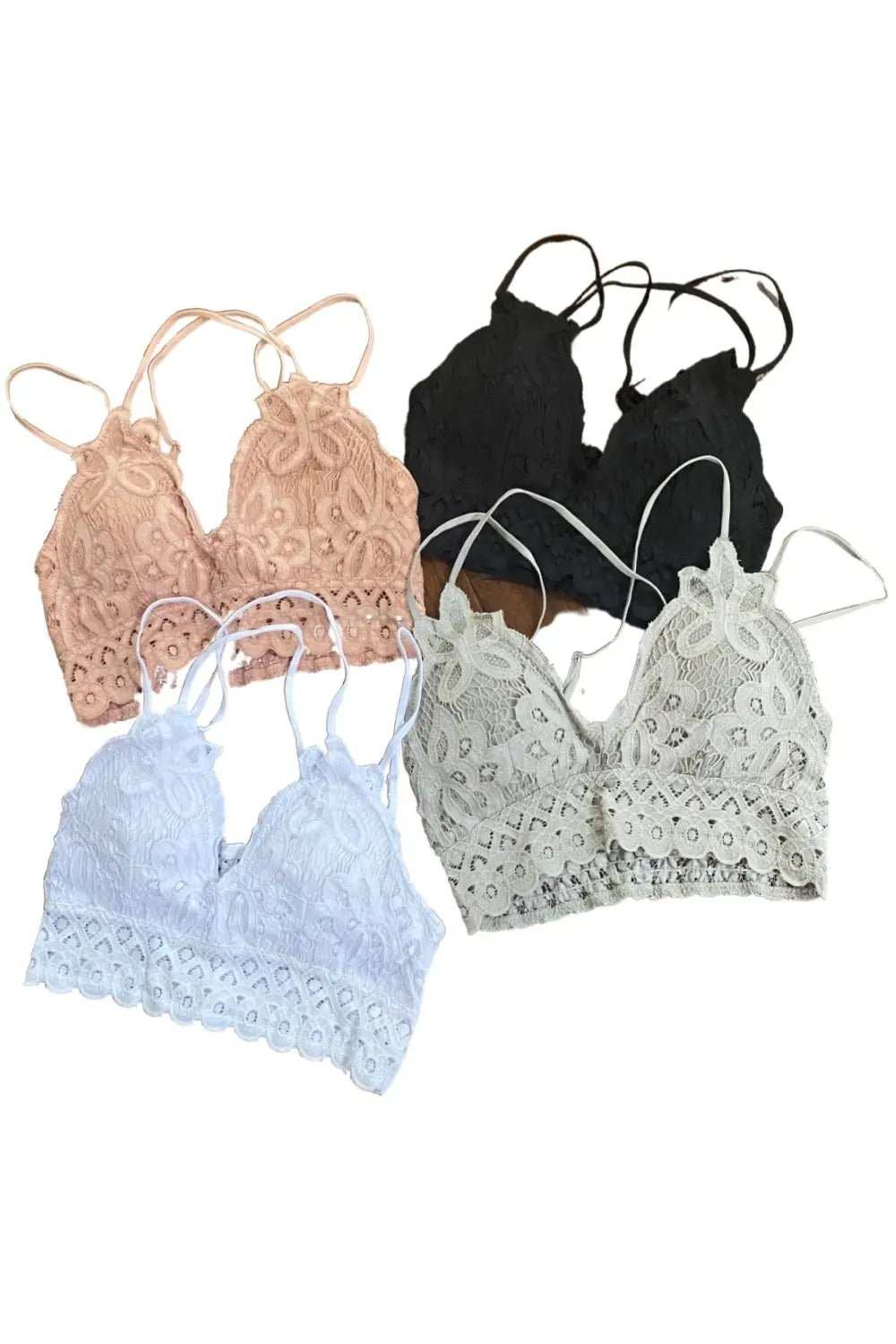 A collection of lace bralettes in black, beige, white, and blue colors, featuring a strappy design and removable padding.