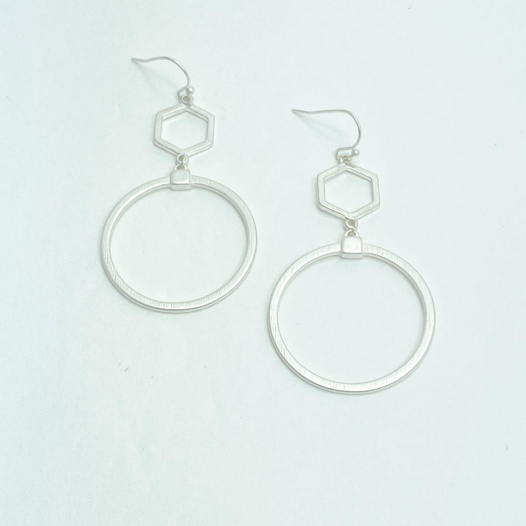 silver ring drop earrings on white background