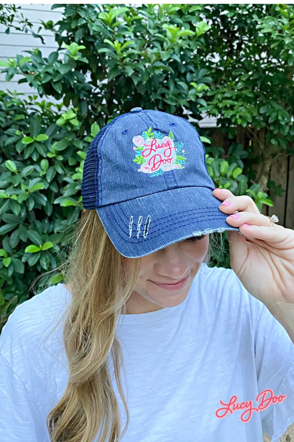 model wearing a denim hat with lucy doo logo